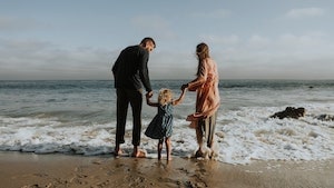 Barefoot family on the beach